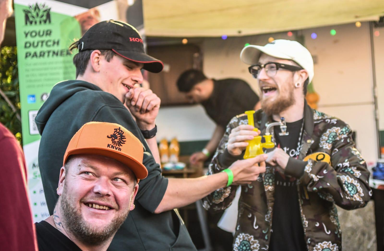 Two visitors laugh together at a festival stand
